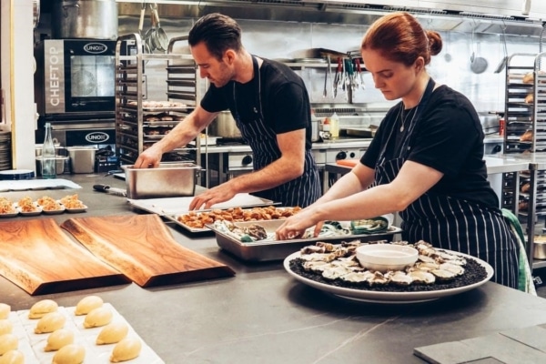 workers preparing food in a commercial kitchen