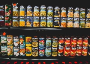 Food cans displayed on a grocery store shelf