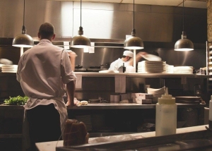 Workers preparing food in the restaurant kitchen