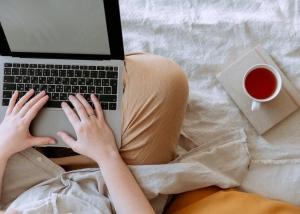 A cup of tea placed next to a person as they work