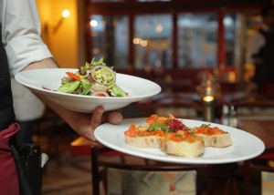 A waiter serving food in a restaurant