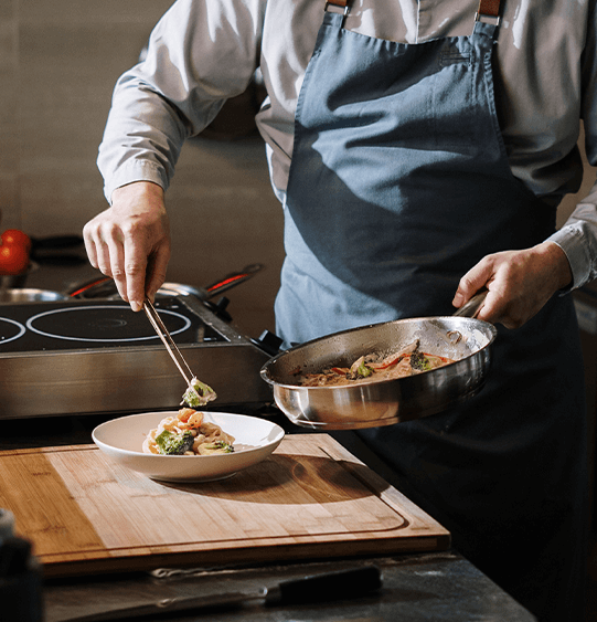 Chef in apron preparing dish