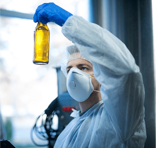 Researcher inspecting glass bottle