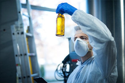 Food researcher inspecting beverage